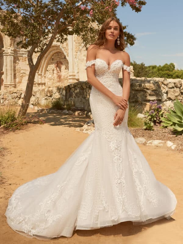 Presenting the sartorial triple-threat: sexy, chic, and timeless, á la this off-the-shoulder elegant bridal dress in flirty lace and impeccable illusion.