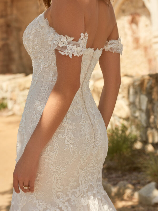 Presenting the sartorial triple-threat: sexy, chic, and timeless, á la this off-the-shoulder elegant bridal dress in flirty lace and impeccable illusion.